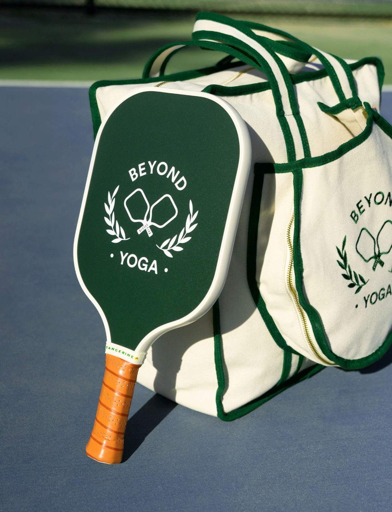 Custom Beyond Yoga pickleball paddle leaning against a custom embroidered bag