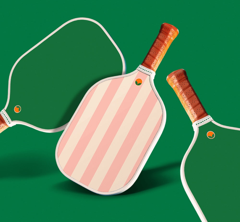 Pink and white pickleball paddle with green backing. 
