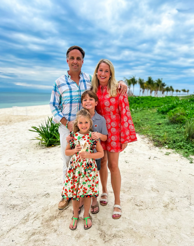 Owners of Tangerine Paddle posing on the beach with their children