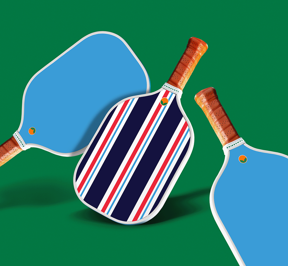 Blue, white, and red striped pickleball paddles beside two blue paddles 