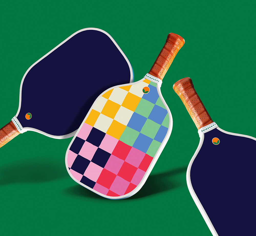 Tangerine pickleball paddle with a checkered colorful design